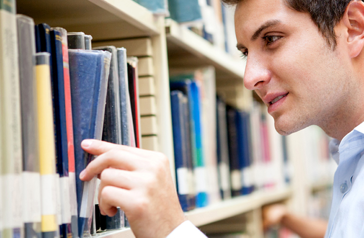 Library volunteer restocking shelf